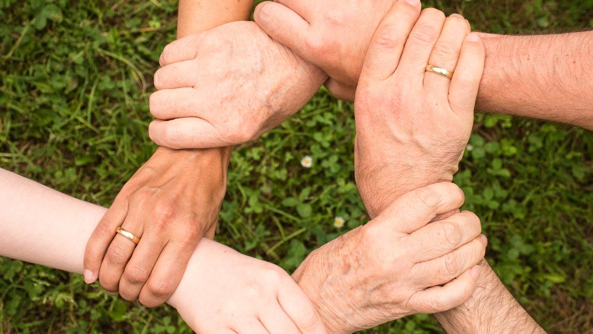A group of people linking arms in support