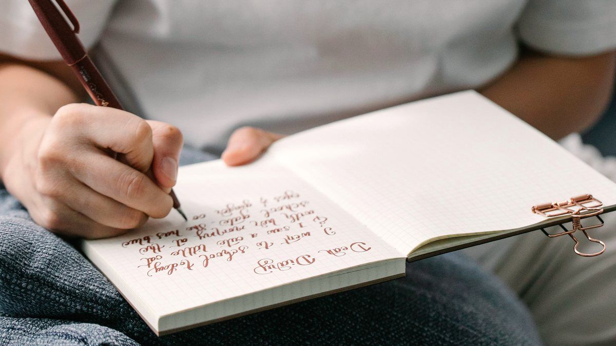 A woman writing quietly in her journal