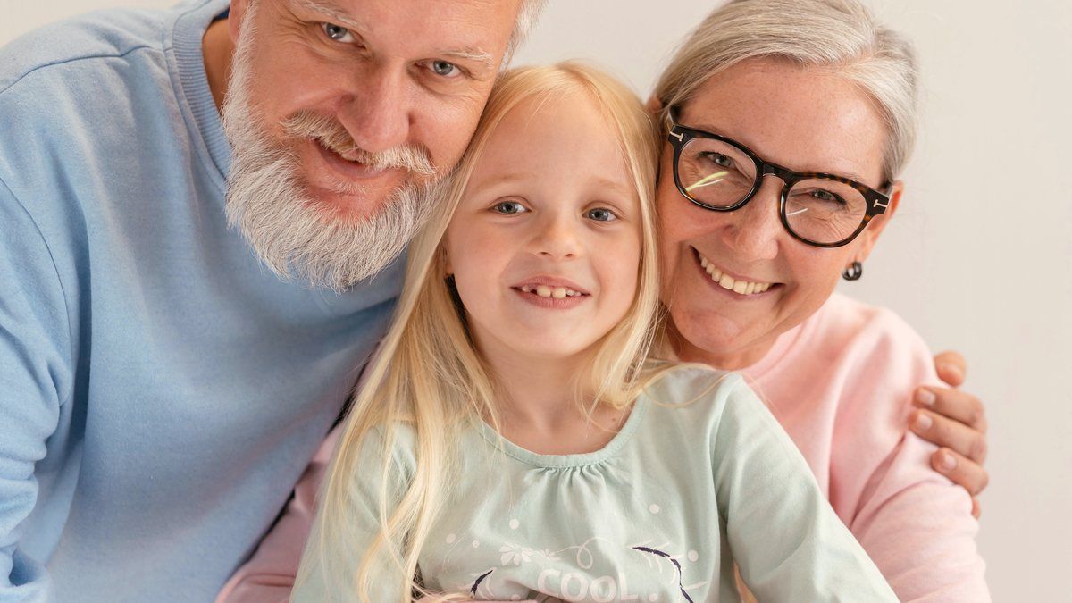 Grandparents holding their grandchild close