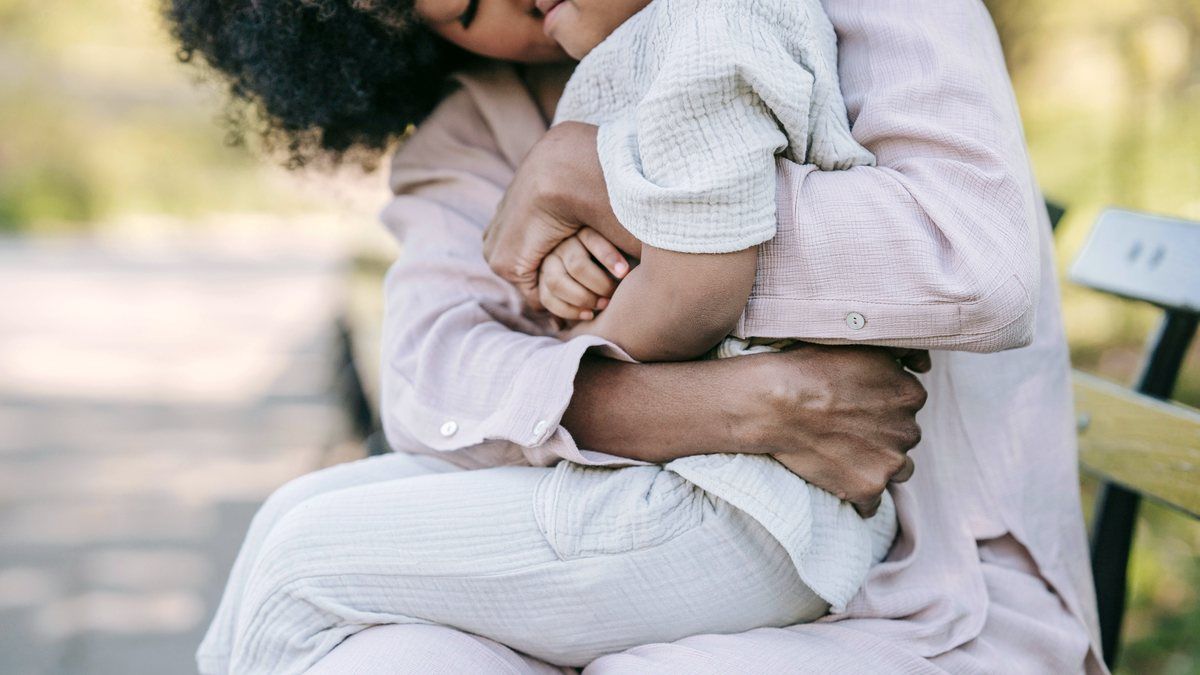 A parent holding their child close